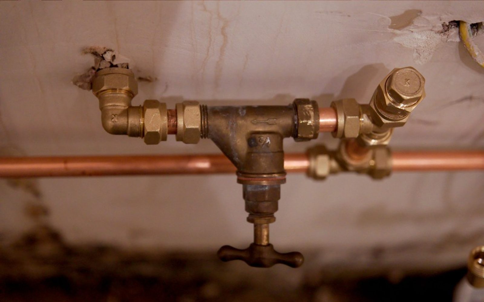 Close macro of copper plumbing pipe and brass fittings